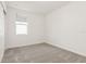 Minimalist bedroom showcasing plush carpet, a bright window and sliding closet doors at 317 Castle Dr, Lake Alfred, FL 33850