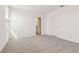 Bright bedroom with neutral carpet, fresh white walls, and an en suite bathroom at 317 Castle Dr, Lake Alfred, FL 33850