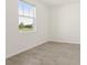 Bright bedroom with tile flooring, a large window, and a serene outdoor view at 317 Castle Dr, Lake Alfred, FL 33850