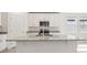 Modern kitchen island with granite countertops and stainless steel appliances, plus a breakfast bar and ample storage at 317 Castle Dr, Lake Alfred, FL 33850