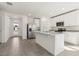 Well-equipped kitchen with stainless steel refrigerator, granite countertops, and an island offering ample counter space at 317 Castle Dr, Lake Alfred, FL 33850