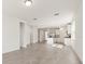 Bright, open living area with tile flooring, neutral walls, and a seamless transition into the modern kitchen at 317 Castle Dr, Lake Alfred, FL 33850