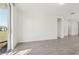 Bright open living area with sliding glass doors to the backyard and neutral tile flooring at 317 Castle Dr, Lake Alfred, FL 33850