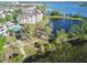 Scenic aerial showcasing the lake, pool, and surrounding residential buildings in the community at 3291 Westchester Square Blvd # 203, Orlando, FL 32835