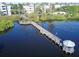 Aerial shot showcasing the wooden pier and gazebo over the pristine lake water at 3291 Westchester Square Blvd # 203, Orlando, FL 32835