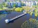 An aerial shot of a lake with a gazebo and walkway that is surrounded by condo buildings at 3291 Westchester Square Blvd # 203, Orlando, FL 32835