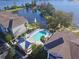 Aerial view featuring pool area with ample lounge chairs and view of the serene lake at 3291 Westchester Square Blvd # 203, Orlando, FL 32835