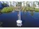 Aerial view of lake with pier, gazebo, and waterfront walking path with lush green landscaping at 3291 Westchester Square Blvd # 203, Orlando, FL 32835