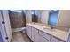 Modern bathroom featuring a double sink vanity, a large mirror, and a tiled shower at 3538 Treetop St, Deland, FL 32724