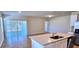 Open-concept kitchen and dining area with stainless steel appliances and access to the backyard at 3538 Treetop St, Deland, FL 32724