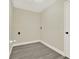 A neutral-toned laundry room featuring vinyl plank flooring and essential appliance connections at 416 Lancaster Ave, Orange City, FL 32763