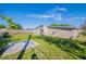 Backyard with a large lawn, and the exterior of the home at 4192 Gallimore St, Orlando, FL 32811