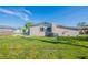 View of a backyard with green grass and the exterior of the home at 4192 Gallimore St, Orlando, FL 32811