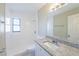 Bathroom featuring granite vanity top, neutral color scheme, and shower with window at 4192 Gallimore St, Orlando, FL 32811