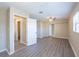 Bedroom featuring neutral walls and wood-look floors with closet and doorway at 4192 Gallimore St, Orlando, FL 32811