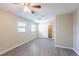 Bedroom featuring ceiling fan, light wood flooring, closet and natural light from two windows at 4192 Gallimore St, Orlando, FL 32811