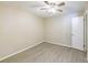 A simplistic bedroom with neutral color palate and new flooring at 4192 Gallimore St, Orlando, FL 32811