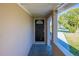 Inviting entryway with a black front door and covered porch area at 4192 Gallimore St, Orlando, FL 32811