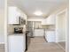 Modern kitchen with stainless steel appliances, sleek white cabinetry, and granite countertops at 4192 Gallimore St, Orlando, FL 32811