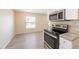 View of stainless steel oven and granite countertops from a kitchen that opens up into the living area at 4192 Gallimore St, Orlando, FL 32811