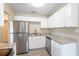 Bright kitchen with granite countertops, stainless steel appliances, and updated cabinets at 4192 Gallimore St, Orlando, FL 32811