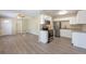 Open-concept kitchen featuring stainless steel appliances, granite countertops, and white cabinets at 4192 Gallimore St, Orlando, FL 32811