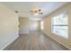 Spacious living room features modern flooring, a ceiling fan, and natural light from large windows at 4192 Gallimore St, Orlando, FL 32811