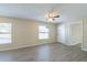 Bright living room with wood-look floors, ceiling fan, and large windows at 4192 Gallimore St, Orlando, FL 32811