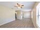 Open concept living room showcasing the new flooring and stainless steel appliances in the kitchen at 4192 Gallimore St, Orlando, FL 32811