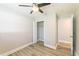 Bedroom with ceiling fan, wood-look flooring, closet with door ajar, and connecting bathroom at 4489 Prince Hall Blvd, Orlando, FL 32811