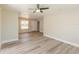 Bright living room features new floors, neutral paint, and a modern ceiling fan at 4489 Prince Hall Blvd, Orlando, FL 32811