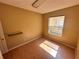 Bright bedroom with wood floors, a built-in shelf, and a window providing natural light at 450 Dewars Ct, Winter Springs, FL 32708