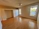 Bright bedroom features hardwood floors, a ceiling fan, and two windows bringing in natural light at 450 Dewars Ct, Winter Springs, FL 32708