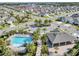 Overhead view of a community pool and amenity center in a neighborhood with lush landscaping at 493 Talisi Loop, St Cloud, FL 34771