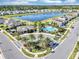 Beautiful aerial view of a community with a lake, pool and lush tropical landscaping at 493 Talisi Loop, St Cloud, FL 34771