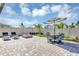 Backyard with firepit, dining table, and lounge chairs, perfect for outdoor entertaining and relaxation at 493 Talisi Loop, St Cloud, FL 34771