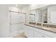 Modern bathroom with double granite vanity and a glass-enclosed shower at 493 Talisi Loop, St Cloud, FL 34771