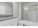 The bathroom features a granite countertop and sliding glass shower doors at 493 Talisi Loop, St Cloud, FL 34771