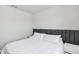 This bedroom features a gray headboard and white linens at 493 Talisi Loop, St Cloud, FL 34771