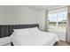 Bedroom with neutral walls, plush carpet, and large window at 493 Talisi Loop, St Cloud, FL 34771