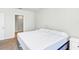 A minimalist bedroom with a view to the bathroom, featuring neutral walls and carpet at 493 Talisi Loop, St Cloud, FL 34771