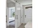 Bright foyer with white trim, barn door and tile flooring at 493 Talisi Loop, St Cloud, FL 34771