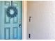 Close-up of a front door with a decorative wreath, showcasing the door's design and entry details at 493 Talisi Loop, St Cloud, FL 34771