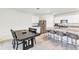 Modern kitchen with stainless steel appliances and seating with a dining area and table nearby at 493 Talisi Loop, St Cloud, FL 34771