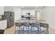 Open kitchen features a large island with counter seating, granite countertops, and stainless steel appliances at 493 Talisi Loop, St Cloud, FL 34771