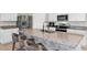 Bright kitchen features an island with counter seating, granite countertops, stainless steel appliances, and white cabinets at 493 Talisi Loop, St Cloud, FL 34771