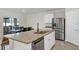 Spacious kitchen includes a large island, stainless steel appliances, and flows into an outdoor dining space at 493 Talisi Loop, St Cloud, FL 34771