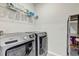 This laundry room has a washer, dryer, and shelving at 493 Talisi Loop, St Cloud, FL 34771