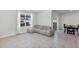 Bright living room with large window, tile flooring, and a comfortable couch at 493 Talisi Loop, St Cloud, FL 34771