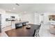 Open-concept kitchen and dining area with modern appliances and tile flooring throughout the living space at 493 Talisi Loop, St Cloud, FL 34771